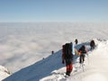 Descending down snowy mountain peak Royalty Free Stock Photo