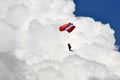 Paratrooper descent with fluffy white cloud background Royalty Free Stock Photo