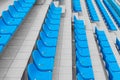 Descending rows of bright spectator seats in sport facility.