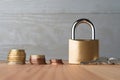 Descending stacks of euro coins with locked golden padlock