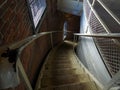 Descending weather-beaten spiral staircase