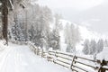 Descending winding country road with the scenic view in the mountains during snowfall   near Sterzing/ Vipiteno South Tyrol, Dol Royalty Free Stock Photo