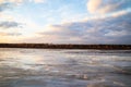 The descent of ice in the spring on the river in March is a natural phenomenon against the sky and clouds in the evening Royalty Free Stock Photo