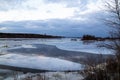 The descent of ice in the spring on the river in March is a natural phenomenon against the sky and clouds in the evening Royalty Free Stock Photo