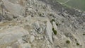 Descent from rocky cliff. Shot. Extreme fast flight from side of rocky mountain on sunny day. Descent by wingsuit or Royalty Free Stock Photo
