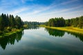 DESCHUTES RIVER WITH A BEAUTIFUL REFLECTION IN THE WATER AND A GRASS AND TREE LINED SHORE Royalty Free Stock Photo