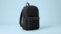 Minimalist Black Backpack on a Light Blue Background Royalty Free Stock Photo