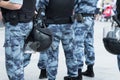 Police squad with helmets, body armor and batons close-up