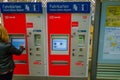 DESDREN, GERMANY - MARZO 23, 2016: Tickets machine on train station, self service. Unidentified woman buying one