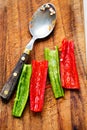 Deseeding green and red chilli peppers before chopping Royalty Free Stock Photo