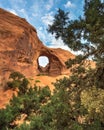 Desert arch with trees and clouds Royalty Free Stock Photo