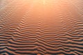 background of a Close-up view of orange nature texture of the sand and dunes rippled surface. Play of lights and darks Royalty Free Stock Photo