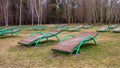 Desert on the beach. Rows of empty sun loungers in early spring