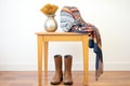 desert boots and ethnic scarf on hearthside stool Royalty Free Stock Photo