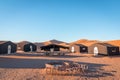 Desert camp and campfire in dunes of Erg Chigaga, at the gates of the Sahara. Morocco. Concept of travel and adventure Royalty Free Stock Photo