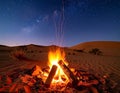 Desert campfire under the stars, captivating contrast of warmth and celestial Royalty Free Stock Photo