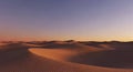 Desert dunes glow gold beneath a lavender twilight sky Royalty Free Stock Photo