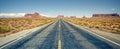 Desert highway leading into Monument Valley Royalty Free Stock Photo