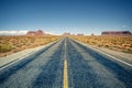 Desert highway leading into Monument Valley Royalty Free Stock Photo