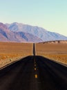 Desert highway and mountains, Death Valley NP Royalty Free Stock Photo