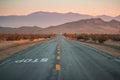 Desert highway road yellow lines mountains and vanishing point Royalty Free Stock Photo