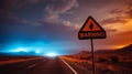 Desert highway scene with a triangular warning sign indicating fire danger Royalty Free Stock Photo