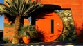 Desert home's round orange door, plants, sunset Royalty Free Stock Photo
