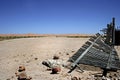 Desert landscape with broken wooden picket fence Royalty Free Stock Photo