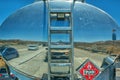 Reflection of the road and cars in the tank on a truck carrying oil, gas, or some other liquid. Royalty Free Stock Photo