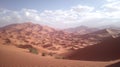 Vast Sahara Desert Landscape with Rolling Sand Dunes and Distant Mountains Royalty Free Stock Photo