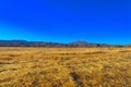 Desert landscape transitioning into mountains