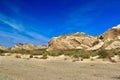 Desert landscape transitioning into dry rocky mountains