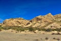 Desert landscape transitioning into dry rocky mountains