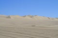 Desert landscape with vast sand dunes in the horizon. Huacachina, Peru.