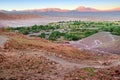 Desert landscape of village and volcanoes near San Pedro de Atacama, Chile, viewed from Pukara de Quitor, against a blue