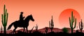 Desert, man riding a horse , cacti, sunset Royalty Free Stock Photo