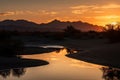 desert mirage reflecting the colors of a sunset, with silhouettes of mountains in the background