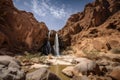 desert mirage of towering waterfall, surrounded by arid desert landscape Royalty Free Stock Photo