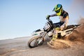 Desert, moto cross or sports adventure athlete in sand for exercise, workout or speed. Travel, dirt and bike with energy