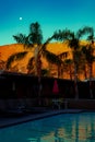 Desert Mountains and Palm Trees Reflected in a Swimming Pool at Night in Palm Springs California Royalty Free Stock Photo