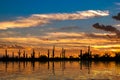 Desert Oasis at Sunset with clouds and orange colored sky Royalty Free Stock Photo