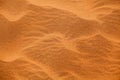 Desert orange sand dunes top view close up, yellow sand texture ornament, desert barchans background Royalty Free Stock Photo
