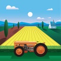 peaceful landscape with 1930\'s retro tractor standing in the field of golden wheat by the farm house against the blue sky Royalty Free Stock Photo