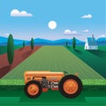 peaceful landscape with 1930\'s retro tractor standing in the field of golden wheat by the farm house against the blue sky Royalty Free Stock Photo