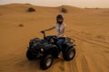 Desert Quad Biking. Young girl in helmet driving a Quad bike Royalty Free Stock Photo