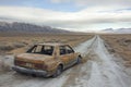 Desert Road Abandonment with Stranded Car Royalty Free Stock Photo