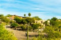 Desert road in the hills of the sonora desert in the hills of arizona with visible houses and homes in mansion community Royalty Free Stock Photo