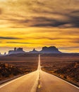 Desert road leading to Monument Valley at sunset Royalty Free Stock Photo