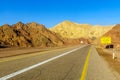 Desert road, with a warning sign Royalty Free Stock Photo
