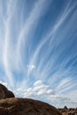 Desert rock formations with clouds in blue sky in Eastern Sierra Nevadas California Royalty Free Stock Photo